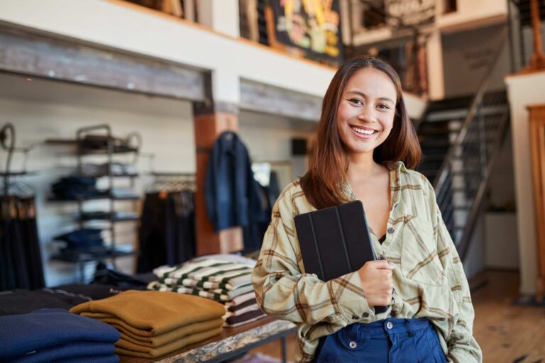 portrait-of-female-owner-of-fashion-store-using-digital-tablet-to-check-stock-in-clothing-store.jpg
